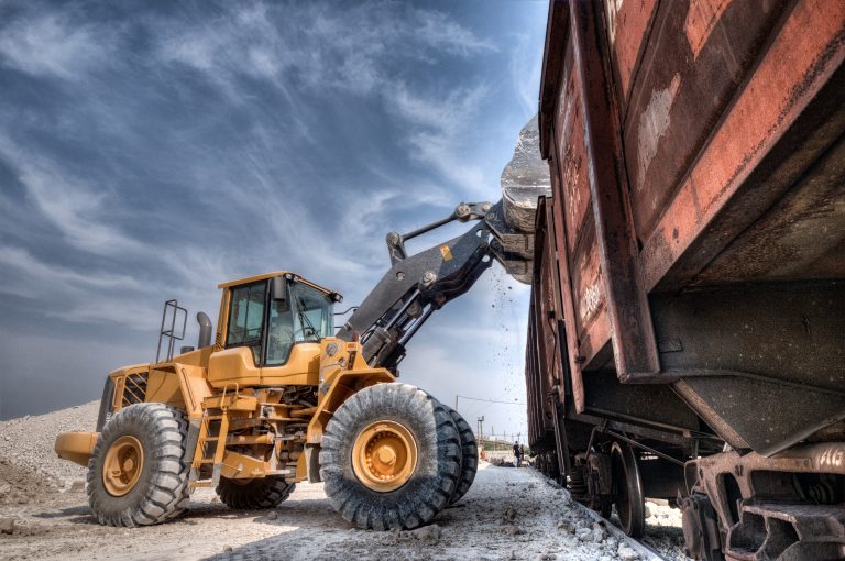 Wheel loader excavator with backhoe unloading clay