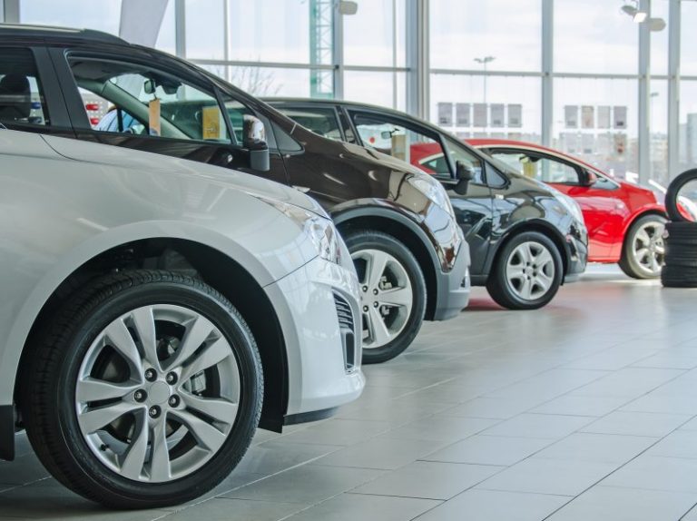 Several new cars at dealership salon.